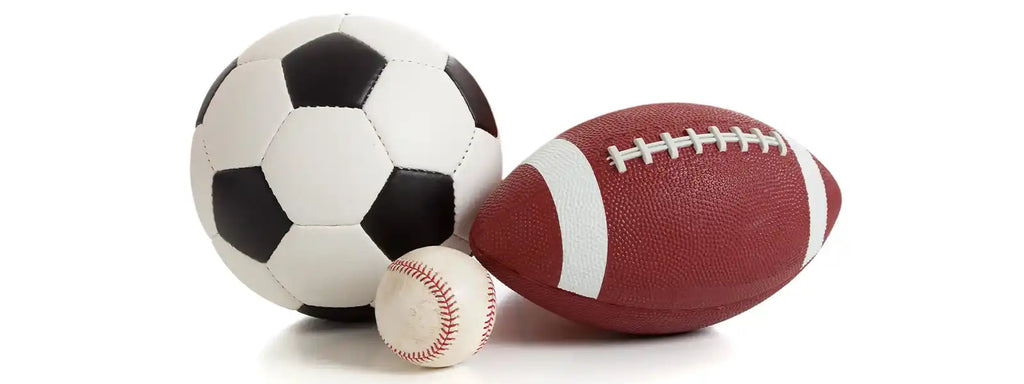 Soccer ball, baseball, and football on grass, symbolizing the versatility of Natur cleats for various sports. Designed for optimal foot support, stability, and natural movement, these cleats are perfect for athletes in soccer, football, baseball, and beyond